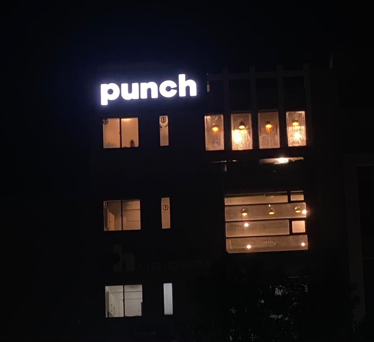 The Punch sign lit at night on the Lahore building