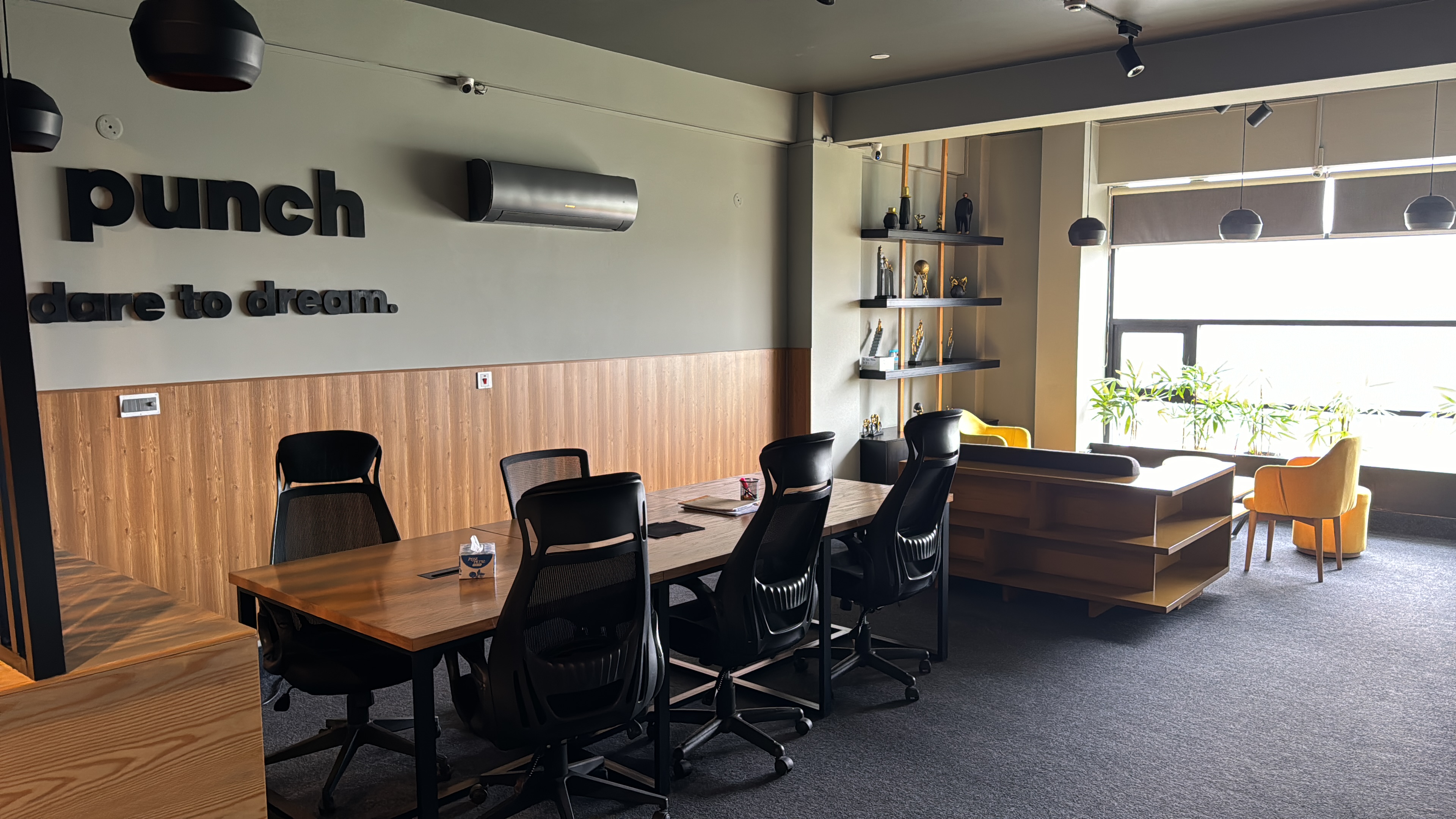 The Punch Lahore studio — 'punch, dare to dream.' on the wall over the work tables