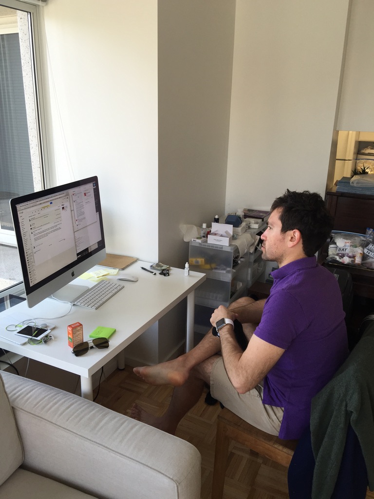 Verdi at the first desk — an iMac on a side table in the apartment
